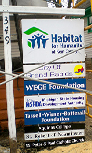 This sign tells the story of the good organizations behind the Habitat LEED restoration of this house in the Wealthy Street neighborhood near Wealthy Theatre. 