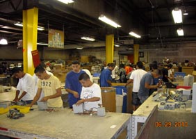 Inner-city students are pictured here in Comprenew’s warehouse this summer learning how to dismantle electronics for safe recycling. Students in the Comprenew Academy are hired for a ten-week course spending part of their day in the classroom learning how to refurbish and fix computers. 
