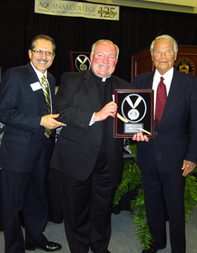 President Oliverez is shown here with Father Duncan (above) as they present the Reflection Award to Ralph Hauenstein. A successful international businessman, Colonel Hauenstein was also a WW II hero as a top intelligence officer under General Dwight Eisenhower. Ralph Hauenstein will celebrate his 100th birthday this year.